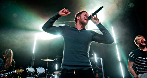 Imagine Dragons' Dan Reynolds (center), Wayne Sermon (left) and Ben McKee perform on stage at Terminal West in Atlanta to a sold out show on Wednesday, February 25, 2015.   