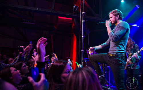 Imagine Dragons' Dan Reynolds plays up to the crowd as he performs on stage at Terminal West in Atlanta to a sold out show on Wednesday, February 25, 2015.   