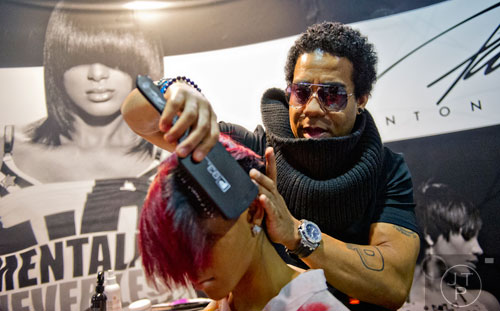Patric Bradley (right) preps a model's hair for a class during the 2015 Bronner Bros. International Beauty Show at the Georgia World Congress Center in Atlanta on Sunday, February 22, 2015. 