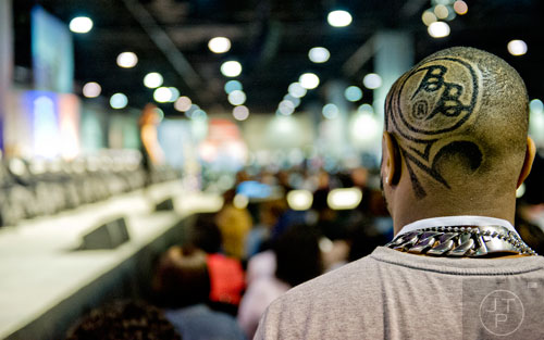 Michael Hood (right) waits for the start of the barber competition during the 2015 Bronner Bros. International Beauty Show at the Georgia World Congress Center in Atlanta on Sunday, February 22, 2015. 