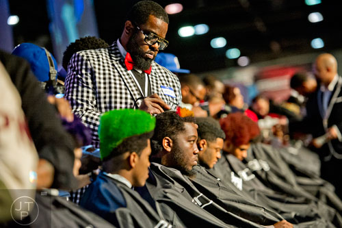 Gerald James Sr. (center) participates in the barber competition during the 2015 Bronner Bros. International Beauty Show at the Georgia World Congress Center in Atlanta on Sunday, February 22, 2015. 