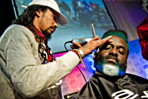 D.C. Murray (left) uses a pair of clippers to shave down Vernon Wright's hair as they participate in the barber competition during the 2015 Bronner Bros. International Beauty Show at the Georgia World Congress Center in Atlanta on Sunday, February 22, 2015. 