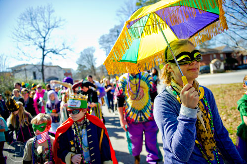 Michelle Cullen (right) marches down Oakview Rd. in Decatur during the Mead St. Mardi Gras parade on Saturday, February 7, 2015.