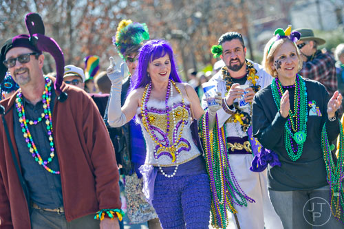 Kate Galatas (left) and her husband Blane march down Oakview Rd. in Decatur during the Mead St. Mardi Gras parade on Saturday, February 7, 2015.