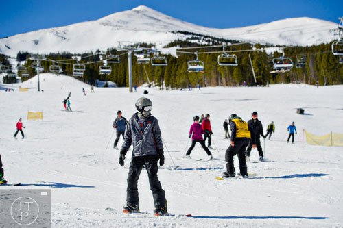 Snowboarders and skiers reach the base of Peak 8 in Breckenridge, Colorado.