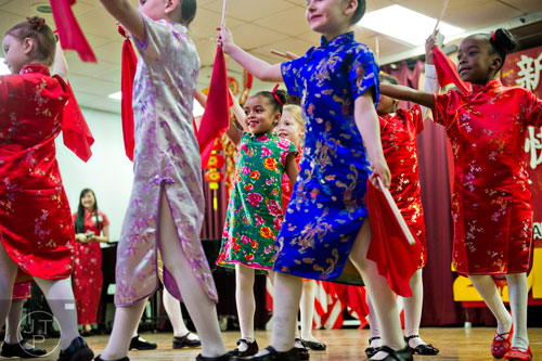 Bella Bryan (center) dances on stage with her classmates during the Chinese Lunar New Year celebration in Chamblee on Saturday, February 21, 2015.