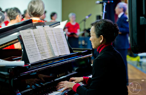 Jinnie Ho (center) plays the piano as she accompanies the Atlanta Taiwanese Philharmonic Chorus during the Chinese Lunar New Year celebration in Chamblee on Saturday, February 21, 2015. 