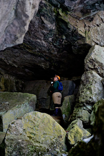 Wildlife biologist Trina Morris shines a light looking for bat groupings around the entrance of Frick's Cave in Chickamauga, Ga. during the Southeastern Cave Conservancy Inc.'s open house on Saturday, February 28, 2015. 
