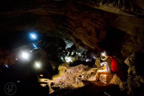 Adam Evans (right) takes a break halfway up a bunch of boulders inside Frick's Cave in Chickamauga, Ga. during the Southeastern Cave Conservancy Inc.'s open house on Saturday, February 28, 2015. 