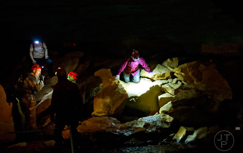 Sally Edwards (right) makes her way down a rock formation past other cavers inside Frick's Cave in Chickamauga, Ga. during the Southeastern Cave Conservancy Inc.'s open house on Saturday, February 28, 2015. 