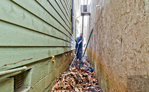 Macarao Alvardo cleans yard debris from the house at 575 Rockwell St. in the Pittsburgh community of Atlanta on Wednesday, March 4, 2015. 