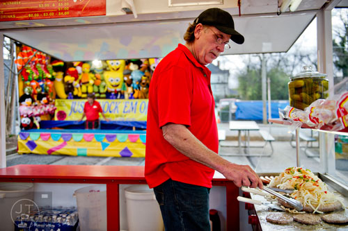 Mike Jeffers checks his peppers, onions and sausages on the grill at the Atlanta Fair on Wednesday, March 4, 2015. 
