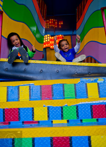Zion Rodgers (left) and his brother Justice sit on the steps leading into the Clown Around fun house at the Atlanta Fair on Wednesday, March 4, 2015. 