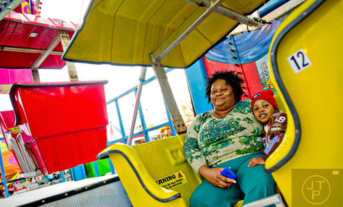 Sophia Barnwell (left) and her grandson Isaac ride the Expo Wheel at the Atlanta Fair on Wednesday, March 4, 2015. 