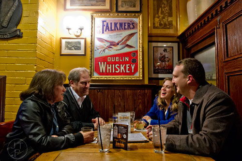 Linda Schultheiss (left) and her husband Bill talk over drinks with Callie Bolduc and her husband Philip at Mac McGee in Roswell on Friday, February 27, 2015. 
