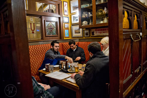 Joseph Jarquin (left) and Luis Esteva talk with friends at Mac McGee in Roswell on Friday, February 27, 2015. 