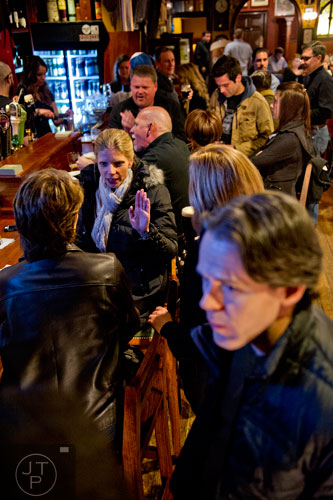 Katja Bryant (left) talks with friends over drinks at Mac McGee in Roswell on Friday, February 27, 2015. 