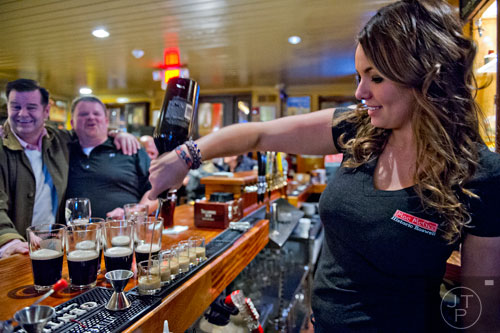 Haleigh Fine (right) pours Irish car bombs for Brett Goodheart and David Burns at Mac McGee in Roswell on Friday, February 27, 2015. 