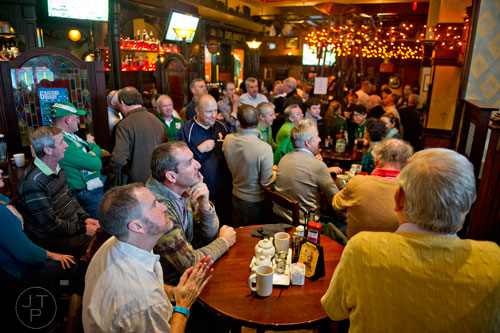 Julian Morton (left) and Eamonn Cunniffe sit around a table inside the packed house  at Fado's Irish Pub in Buckhead on Sunday, March 1, 2015. 