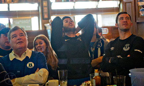 Neal Coffey (center) reacts to the third round of the Six Nations rugby tournament as Ireland matched up against England at Fado's Irish Pub in Buckhead on Sunday, March 1, 2015.