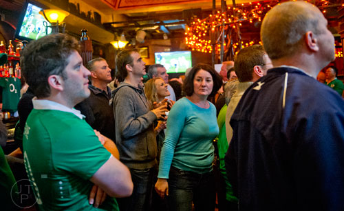 Julie Callaghan (center) makes her way through the packed bar at Fado's Irish Pub in Buckhead on Sunday, March 1, 2015.