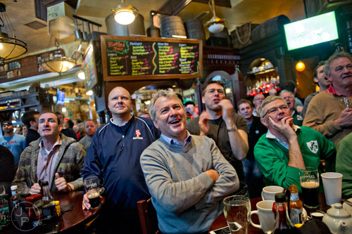 Tom Daly (center) reacts to the third round of the Six Nations rugby tournament as Ireland defeated England at Fado's Irish Pub in Buckhead on Sunday, March 1, 2015. 