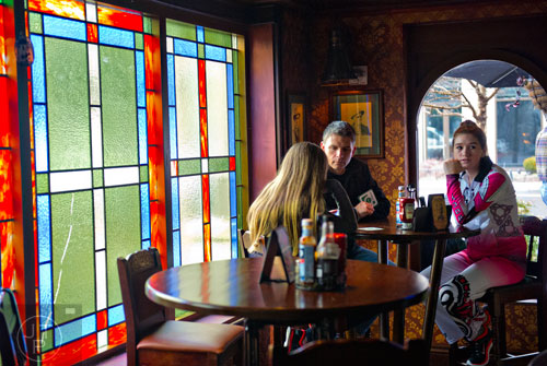 Jim Morecraft (center) talks to his daughters Keelin (left) and Brenna at Fado's Irish Pub in Buckhead on Sunday, March 1, 2015. 