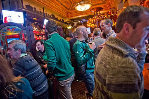 Brian Mahony (center) holds his beer as he talks to friends at Fado's Irish Pub in Buckhead on Sunday, March 1, 2015.