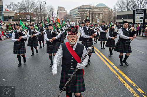 Don Bogue (center) leads the Atholl Highlanders Pipes & Drums down Peachtree St. during the 2015 Atlanta St. Patrick's Parade on Saturday, March 14, 2015. 