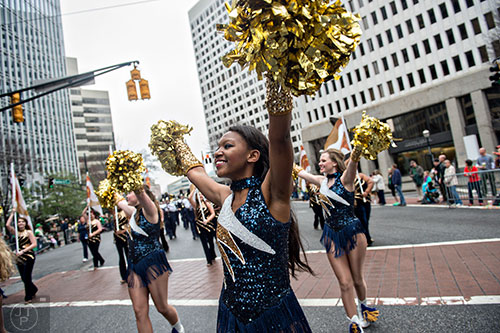 Shatoya Teague (center) marches down Peachtree St. during the 2015 Atlanta St. Patrick's Parade on Saturday, March 14, 2015. 