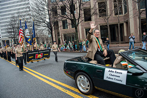 Fulton County Chairman John Eaves (right) waves to the crowd as he rides down Peachtree St. during the 2015 Atlanta St. Patrick's Parade on Saturday, March 14, 2015. 