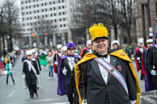 Tom Frizzi (right) marches down Peachtree St. during the 2015 Atlanta St. Patrick's Parade on Saturday, March 14, 2015.