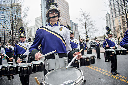 Simon Butterworth (center) plays his snare drum as he marches down Peachtree St. during the 2015 Atlanta St. Patrick's Parade on Saturday, March 14, 2015. 