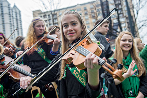 Madeline Dierauf plays a fiddle as she rides on a float during the 2015 Atlanta St. Patrick's Parade on Saturday, March 14, 2015. 