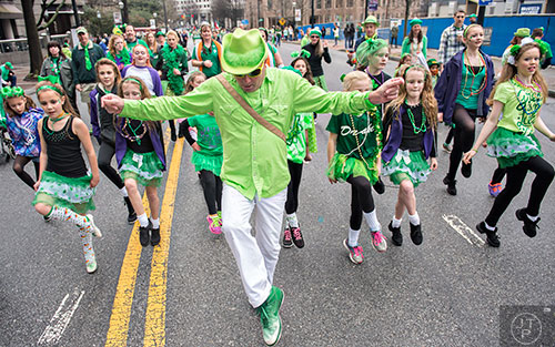 Karl Drake (center) leads his dancers down Peachtree St. during the 2015 Atlanta St. Patrick's Parade on Saturday, March 14, 2015. 