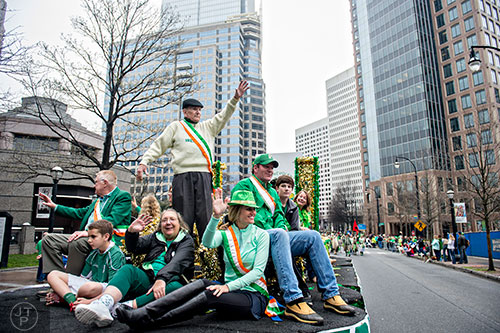 Pat Egan (standing left) waves to the crowd from a float during the 2015 Atlanta St. Patrick's Parade on Saturday, March 14, 2015. 