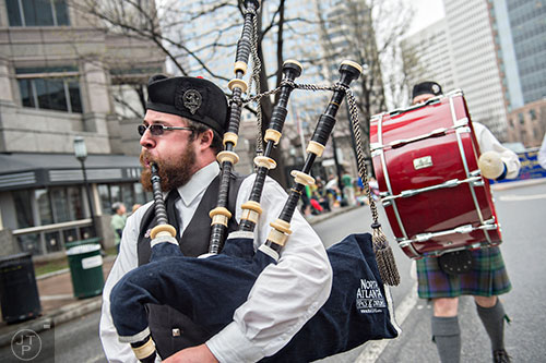 Daniel Bollinger plays the bagpipes as he marches down Peachtree St. during the 2015 Atlanta St. Patrick's Parade on Saturday, March 14, 2015. 