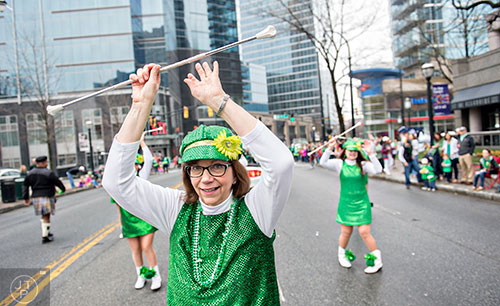 Connie Morello (center) turns and twirls her baton as she dances down Peachtree St. during the 2015 Atlanta St. Patrick's Parade on Saturday, March 14, 2015.