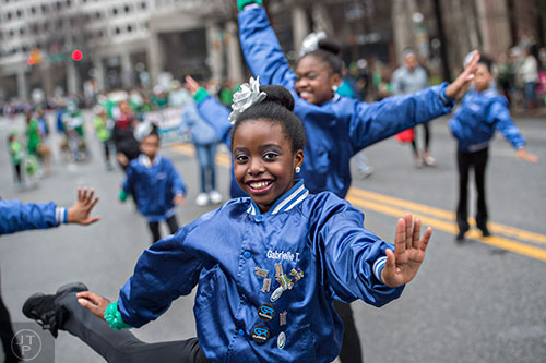 Gabrielle Turner (center) dances her way down Peachtree St. during the 2015 Atlanta St. Patrick's Parade on Saturday, March 14, 2015.