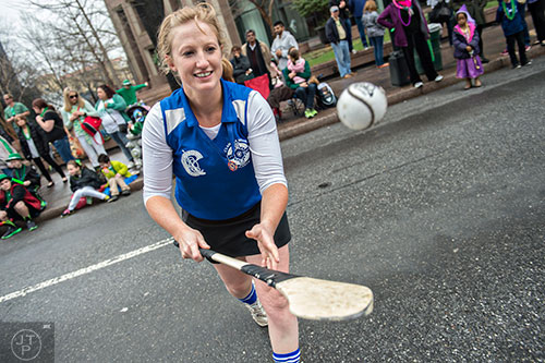 Fiona O'Donoghue with the Clan Na Ngael team catches a ball as she marches down Peachtree St. during the 2015 Atlanta St. Patrick's Parade on Saturday, March 14, 2015. 