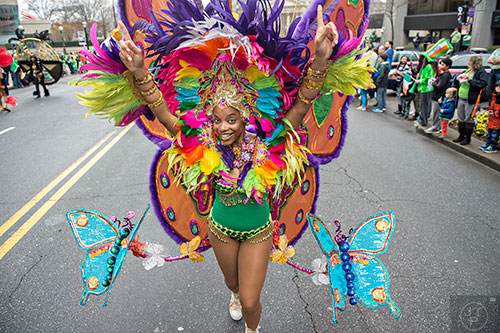 Krystal Gill dances her way down Peachtree St. during the 2015 Atlanta St. Patrick's Parade on Saturday, March 14, 2015. 