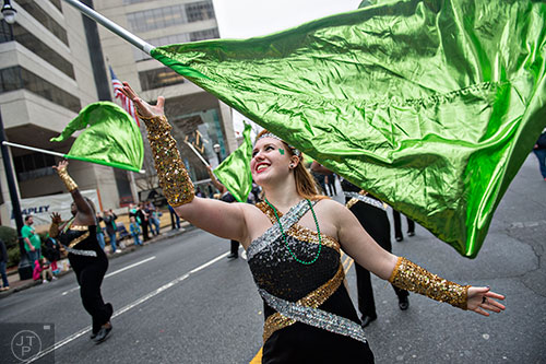 Coral Mace tosses her flag in the air as she marches down Peachtree St. during the 2015 Atlanta St. Patrick's Parade on Saturday, March 14, 2015. 
