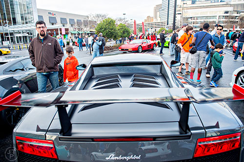 Jason Hoch (left) and his son Charlie walk past one of the numerous Lamborghinis that were present during the Caffeine & Exotics Car Show at Lenox Square Mall in Atlanta on Sunday, March 15, 2015.