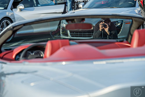 John Roper takes a photo of a Aston Martin DBS during the Caffeine & Exotics Car Show at Lenox Square Mall in Atlanta on Sunday, March 15, 2015. 