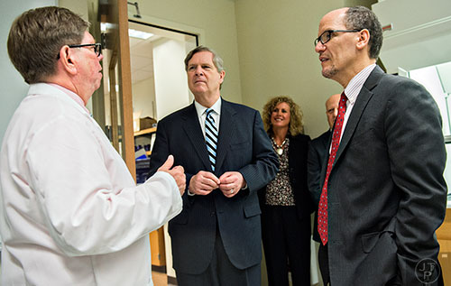 Secretary of Labor Thomas Perez (right) and Secretary of Agriculture Tom Vilsack speak with Dr. Robert Powers during a tour of Gwinnett Technical College in Lawrenceville on Friday, March 20, 2015.  