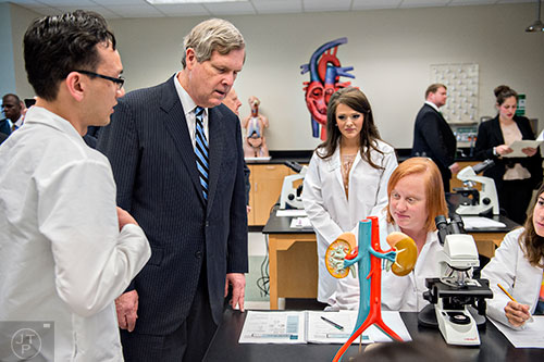 U.S. Secretary of Agriculture Tom Vilsack (center) speaks with students during a tour of Gwinnett Technical College in Lawrenceville on Friday, March 20, 2015.  