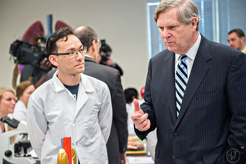 U.S. Secretary of Agriculture Tom Vilsack (right) speaks with Kang Nguyen during a tour of Gwinnett Technical College in Lawrenceville on Friday, March 20, 2015.