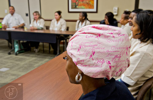 Wearing a pink scarf with words of encouragement, Erica Lynn (center) participates in the daily Environmental Services staff alignment meeting at the Cancer Treatment Centers of America's Southeastern Regional Medical Center in Newnan on Friday, February 20, 2015.   
