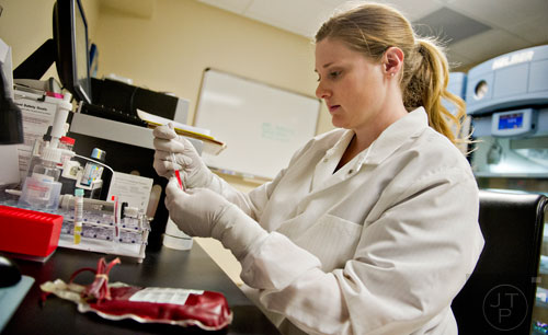 Kimberly Freyman works on a blood sample out of a centrifuge while working in the blood bank at the Cancer Treatment Centers of America's Southeastern Regional Medical Center in Newnan on Friday, February 20, 2015.  