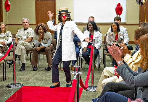 Chief Executive Officer Anne Meisner walks up the red carpet during a staff bash team building event at the Cancer Treatment Centers of America's Southeastern Regional Medical Center in Newnan on Friday, February 20, 2015.